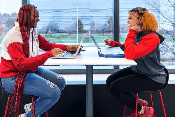 Two students talk as they study in the ICTC Building