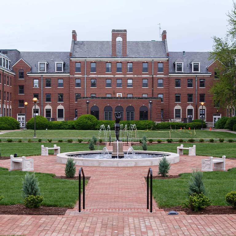 Image of Ball Residence Hall and the focus is on the beautiful foundation within the Ball Hall gardens.