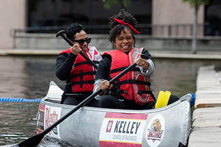 Two female students bump into the walls of the canal in their canoe during the IU Indianapolis Regatta