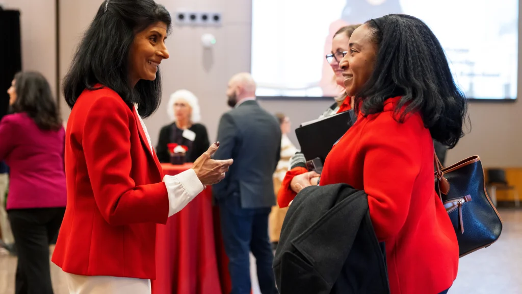 Chancellor Latha Ramchand speaks with faculty and staff at a Campus Center event.