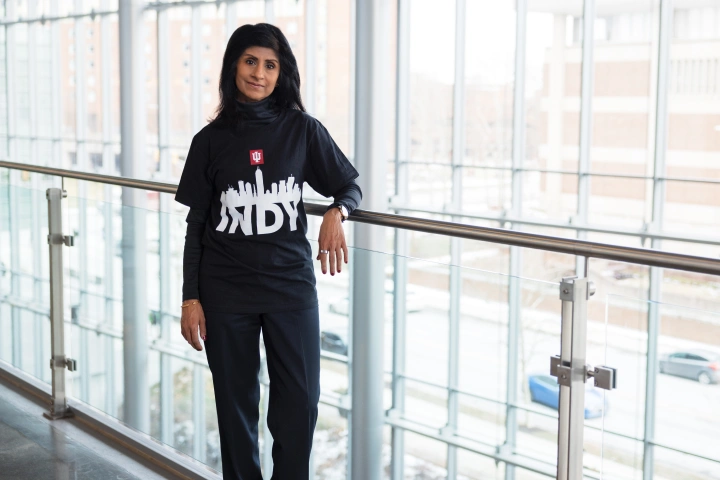 Dr. Ramchand stands in the Luddy School building wearing an Indy t-shirt