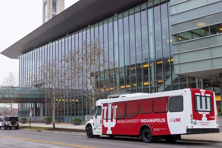 A red and white Jagline bus sits outside the Campus Center front door.